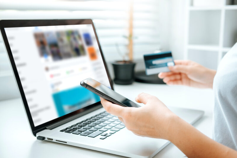 Shopping online icon , Online banking woman using Laptop ,smartphone holding credit card online shopping concept.