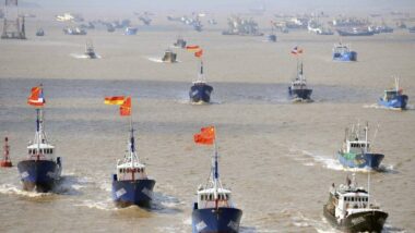 Fishing boats are seen departing from Shenjiawan port towards the East China Sea, in Zhoushan