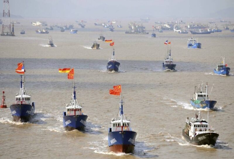 Fishing boats are seen departing from Shenjiawan port towards the East China Sea, in Zhoushan